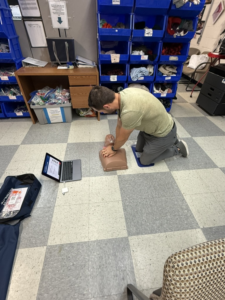 Student practicing chest compressions during CPR training
