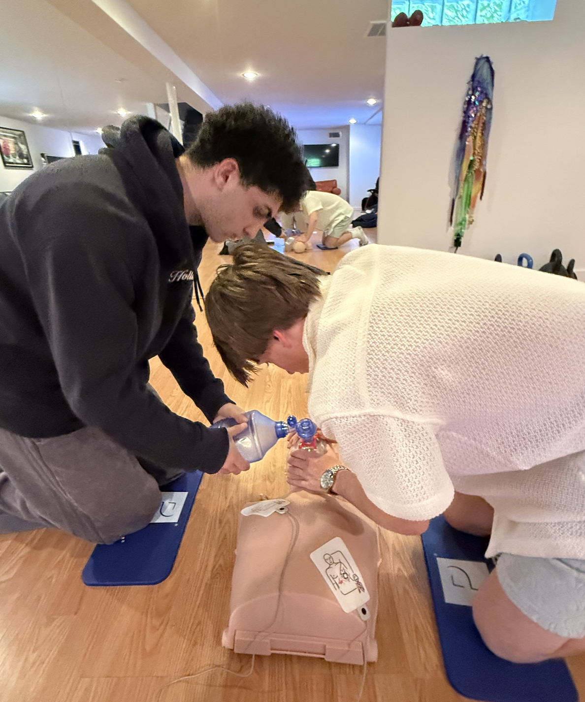 Instructor demonstrating bandaging technique to first aid class