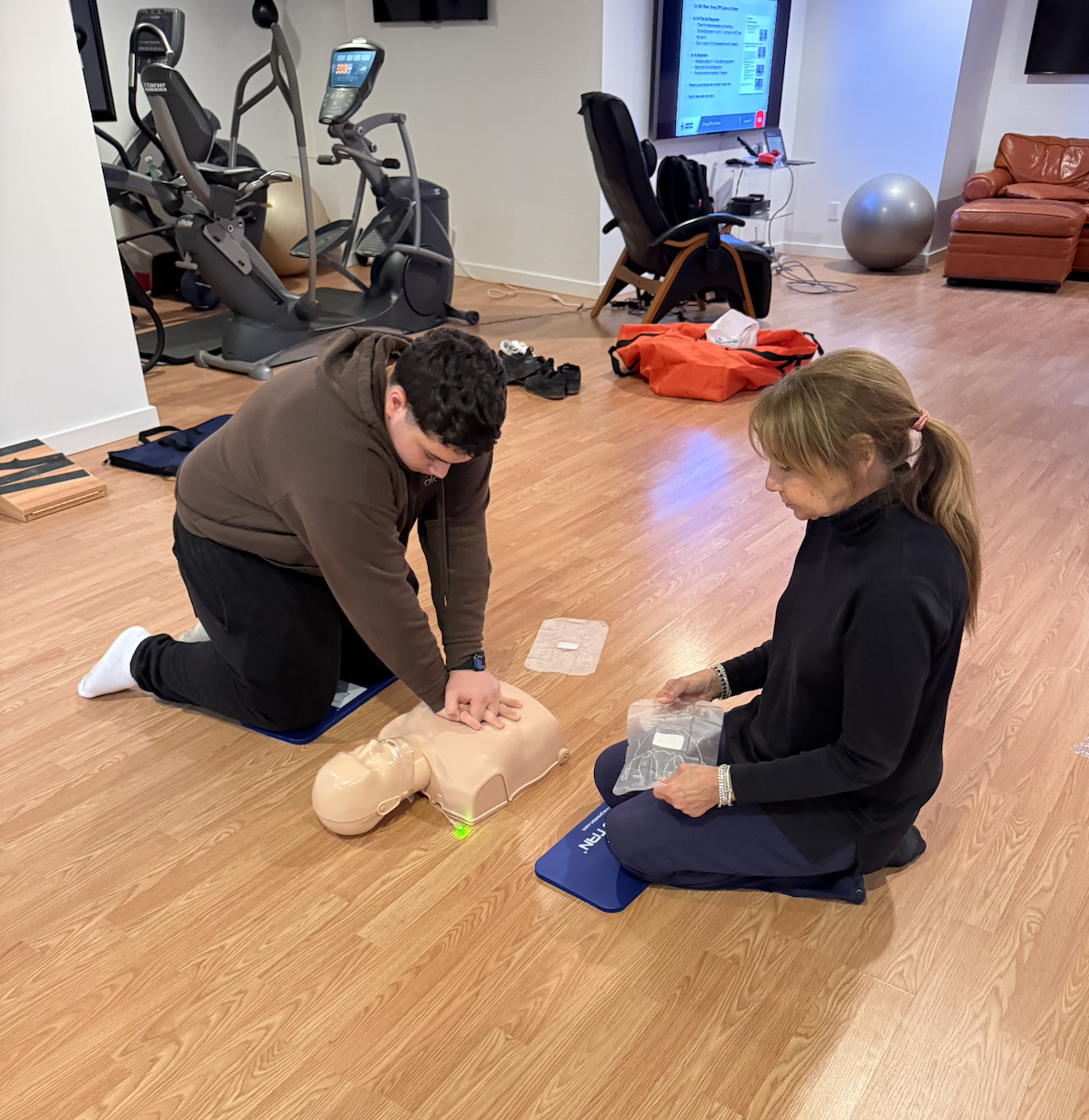 Close-up of AED training pads being placed on a manikin
